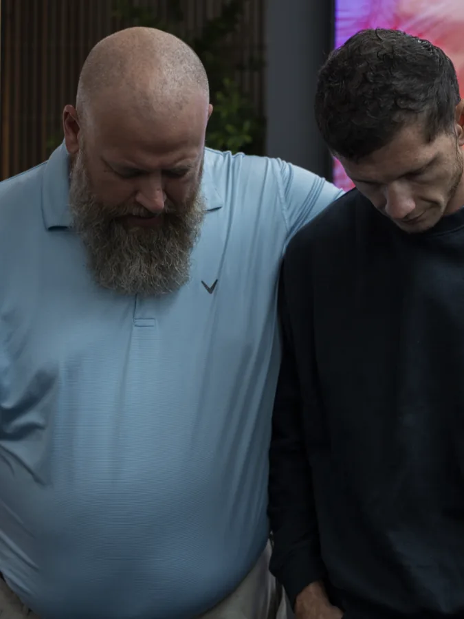 Two men praying together during worship at Mission View Baptist