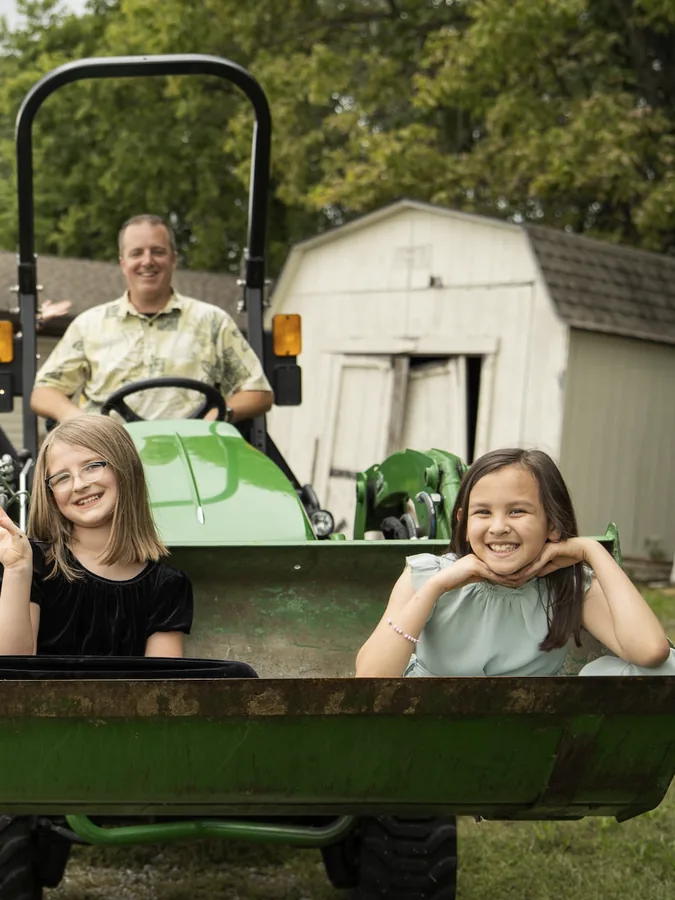 Kids riding a tractor and hay wagon at a Mission View church event